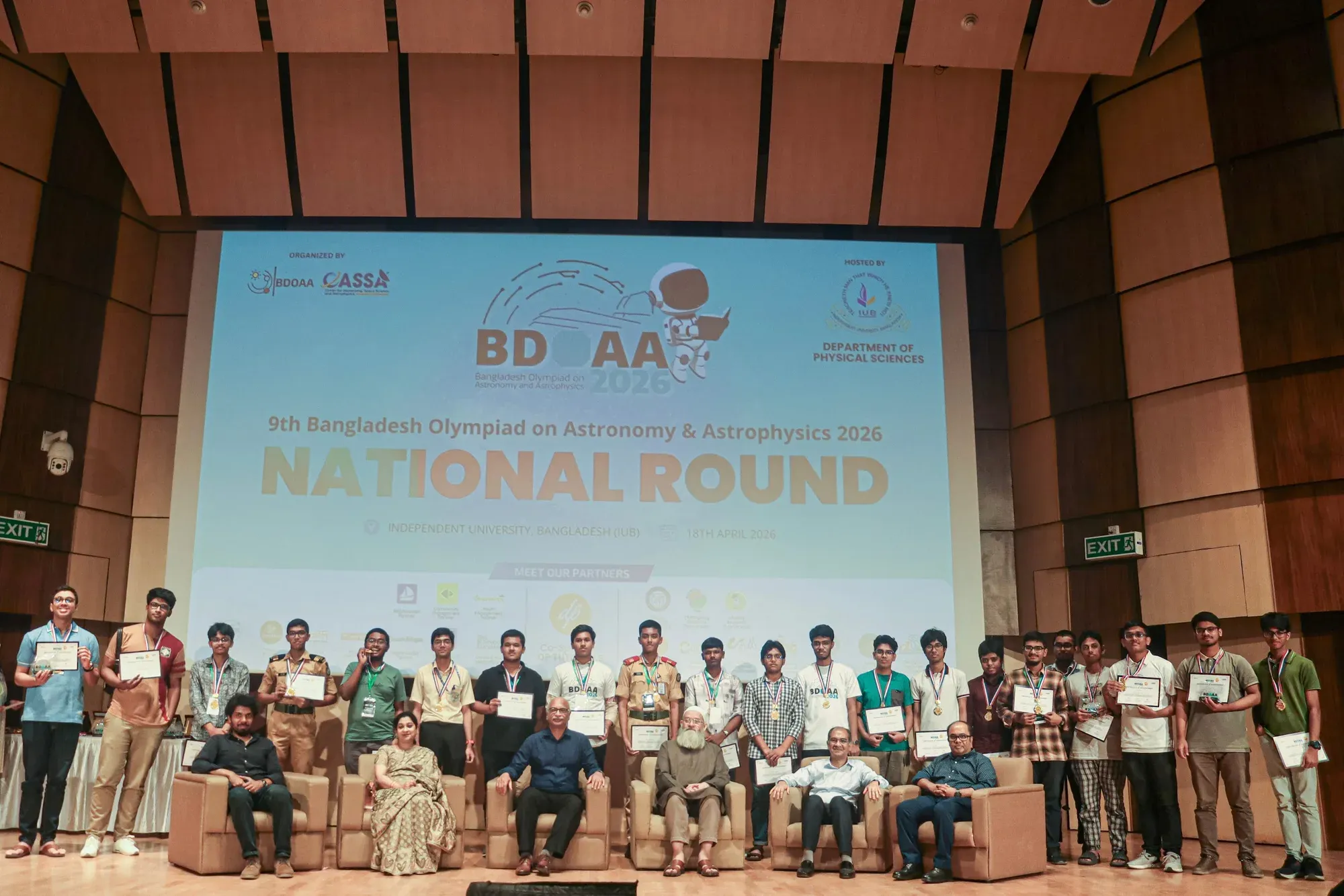 Senior-category winners of the 9th BDOAA National Round holding their certificates beneath the event banner at IUB.