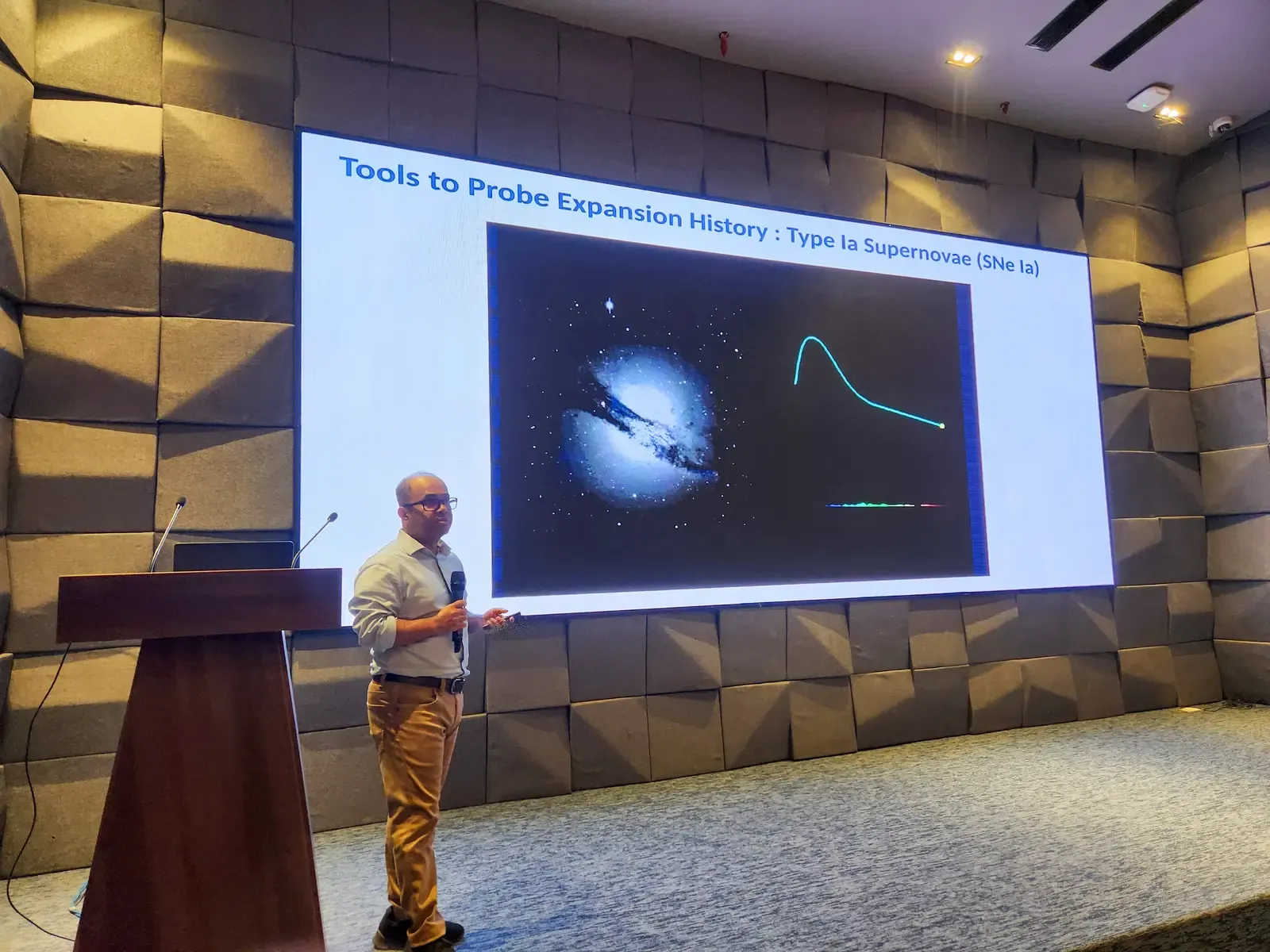 Syed Ashraf Uddin presenting at the third CASSA colloquium, beside a slide on probing cosmic expansion history with Type Ia supernovae.