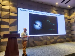 Syed Ashraf Uddin presenting at the third CASSA colloquium, beside a slide on probing cosmic expansion history with Type Ia supernovae.